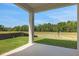Covered patio offers relaxing view of the backyard and green surroundings at 2950 Supermarine Rd, Tavares, FL 32778