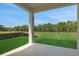 Covered patio offers relaxing view of the backyard and green surroundings at 2950 Supermarine Rd, Tavares, FL 32778