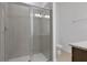 Modern bathroom features a large glass enclosed shower with tile surround and sleek fixtures at 2950 Supermarine Rd, Tavares, FL 32778