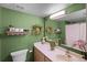 Bright bathroom featuring decorative shelving, a mirror, and green paint at 3215 Park Branch Ave, Clermont, FL 34711