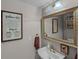 Cozy half bathroom featuring modern fixtures, stylish mirror, and quirky bathroom decor at 3215 Park Branch Ave, Clermont, FL 34711