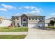 Charming two-story home with well-maintained lawn, three-car garage, and inviting curb appeal at 3215 Park Branch Ave, Clermont, FL 34711