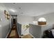 Bright second story hallway with hardwood floors, neutral paint, and a view of the staircase at 3215 Park Branch Ave, Clermont, FL 34711
