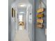 Bright hallway with neutral paint leads to a cozy sitting room at 3215 Park Branch Ave, Clermont, FL 34711