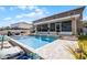 Backyard swimming pool featuring a waterfall, screened-in patio, and lounge area at 3215 Park Branch Ave, Clermont, FL 34711