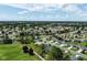 Scenic aerial view highlighting a well-planned residential area with golf course and neatly arranged homes at 3218 Woodridge Dr, The Villages, FL 32162