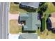 A bird's-eye view showcasing the home's roof, landscaping, and brick driveway at 3218 Woodridge Dr, The Villages, FL 32162