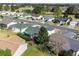 An aerial view of a lovely home in a well-maintained community, close to a main road at 3218 Woodridge Dr, The Villages, FL 32162