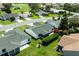 Aerial view of a home with a manicured backyard, mature landscaping, and a screened-in lanai at 3218 Woodridge Dr, The Villages, FL 32162