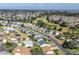 Wide aerial view of the community, a golf course, and nearby lake at 3218 Woodridge Dr, The Villages, FL 32162