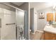 Modern bathroom features shower, vanity with wooden cabinets, and is decorated with artistic details at 3218 Woodridge Dr, The Villages, FL 32162