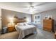 Cozy bedroom features a ceiling fan, plantation shutters, soft grey color scheme, and comfortable furnishings at 3218 Woodridge Dr, The Villages, FL 32162