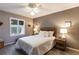 Serene bedroom featuring neutral walls, white bedding, and natural light from shuttered windows at 3218 Woodridge Dr, The Villages, FL 32162