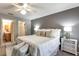 Comfortable bedroom features a ceiling fan, a large bed and ensuite bathroom at 3218 Woodridge Dr, The Villages, FL 32162
