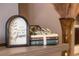 Charming home decor featuring stacked books, greenery, and a vase on a stylish shelf, adding warmth to the space at 3218 Woodridge Dr, The Villages, FL 32162