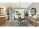 Charming dining area adjacent to the kitchen, featuring a round table with seating for four and stylish decor at 3218 Woodridge Dr, The Villages, FL 32162