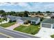 Charming single-story home with a well-manicured lawn, attached garage, and inviting curb appeal at 3218 Woodridge Dr, The Villages, FL 32162