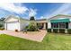 Charming single story home with beautiful landscaping, brick walkway and two car garage at 3218 Woodridge Dr, The Villages, FL 32162