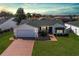 Well-maintained single-story home boasts beautiful landscaping, a two-car garage, and a charming brick driveway at 3218 Woodridge Dr, The Villages, FL 32162