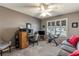 Cozy home office with a ceiling fan, stationary bike, and lots of natural light from the window with plantation shutters at 3218 Woodridge Dr, The Villages, FL 32162