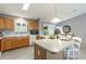 Sunlit kitchen with ample counter space, wood cabinets, and modern appliances at 3218 Woodridge Dr, The Villages, FL 32162