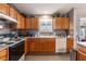 Kitchen featuring oak cabinetry, tile backsplash, stainless steel appliances, and gray walls at 3218 Woodridge Dr, The Villages, FL 32162
