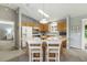 Bright kitchen with oak cabinets, a center island, a skylight, and modern appliances at 3218 Woodridge Dr, The Villages, FL 32162