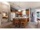 Kitchen and eat-in-kitchen featuring light oak cabinetry, an island with stool seating, and updated appliances at 3218 Woodridge Dr, The Villages, FL 32162