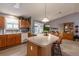 Bright kitchen with an island, stool seating, and sliding glass doors to the exterior patio dining area at 3218 Woodridge Dr, The Villages, FL 32162