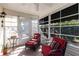 Enclosed lanai with comfortable seating and plenty of natural light for relaxing or entertaining guests at 3218 Woodridge Dr, The Villages, FL 32162