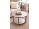 Cozy living room showcases stylish round coffee table with decor and comfortable seating arrangement at 3218 Woodridge Dr, The Villages, FL 32162
