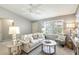 Cozy living room filled with natural light, featuring plantation shutters, a comfortable sofa, and decorative accents at 3218 Woodridge Dr, The Villages, FL 32162