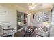 Relaxing sun room with comfortable seating, a ceiling fan, and sliding doors with outdoor views at 3218 Woodridge Dr, The Villages, FL 32162