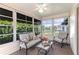 Bright sunroom featuring comfortable seating, large windows, and a ceiling fan, perfect for relaxing and enjoying natural light at 3218 Woodridge Dr, The Villages, FL 32162