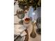 Charming table setting featuring decorative glassware, candles, and a small cake with fresh berries at 3218 Woodridge Dr, The Villages, FL 32162