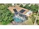 Aerial view of a backyard showing screened-in pool, patio furniture, and solar panels on the house's roof at 3310 Osprey Hill St, Clermont, FL 34714