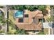 Aerial view of roof with pool, solar panels and surrounding greenery at 3310 Osprey Hill St, Clermont, FL 34714