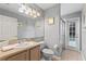 Bathroom with a shower, big mirror, sink, toilet and a door leading to the pool at 3310 Osprey Hill St, Clermont, FL 34714