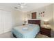 Comfortable bedroom with a plush bed, side tables and closet with flower decorations above the bed at 3310 Osprey Hill St, Clermont, FL 34714