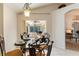 Eat-in kitchen featuring a modern chandelier, table setting, and views of the living area at 3310 Osprey Hill St, Clermont, FL 34714