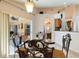 Dining room features modern chandelier, table setting, and views of the lanai at 3310 Osprey Hill St, Clermont, FL 34714