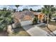 Front exterior view of a single-Gathering home with a two-car garage, well-maintained lawn, and landscaping at 3310 Osprey Hill St, Clermont, FL 34714