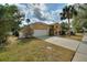 Well-manicured lawn and long driveway lead up to a two-car garage at 3310 Osprey Hill St, Clermont, FL 34714