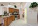 Bright kitchen showcasing tiled floors, stainless appliances, and oak cabinets at 3310 Osprey Hill St, Clermont, FL 34714