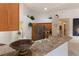 Spacious kitchen area featuring a stainless fridge, island with sink, and breakfast bar at 3310 Osprey Hill St, Clermont, FL 34714