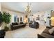 Bright living room with tile floors, slider to patio, neutral paint, and open concept layout at 3310 Osprey Hill St, Clermont, FL 34714