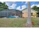 Backyard showing enclosed pool with covered patio and plenty of greenery creating a private retreat at 3310 Osprey Hill St, Clermont, FL 34714