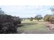 Sprawling horse property with fenced pastures, trees, and a distant house at 37807 Felkins Rd, Leesburg, FL 34788