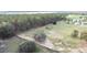 Aerial view of a fenced-in horse property with a lush green landscape and mature trees at 37807 Felkins Rd, Leesburg, FL 34788