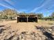 Outdoor animal shelter with partial fencing and covered roofing at 37807 Felkins Rd, Leesburg, FL 34788